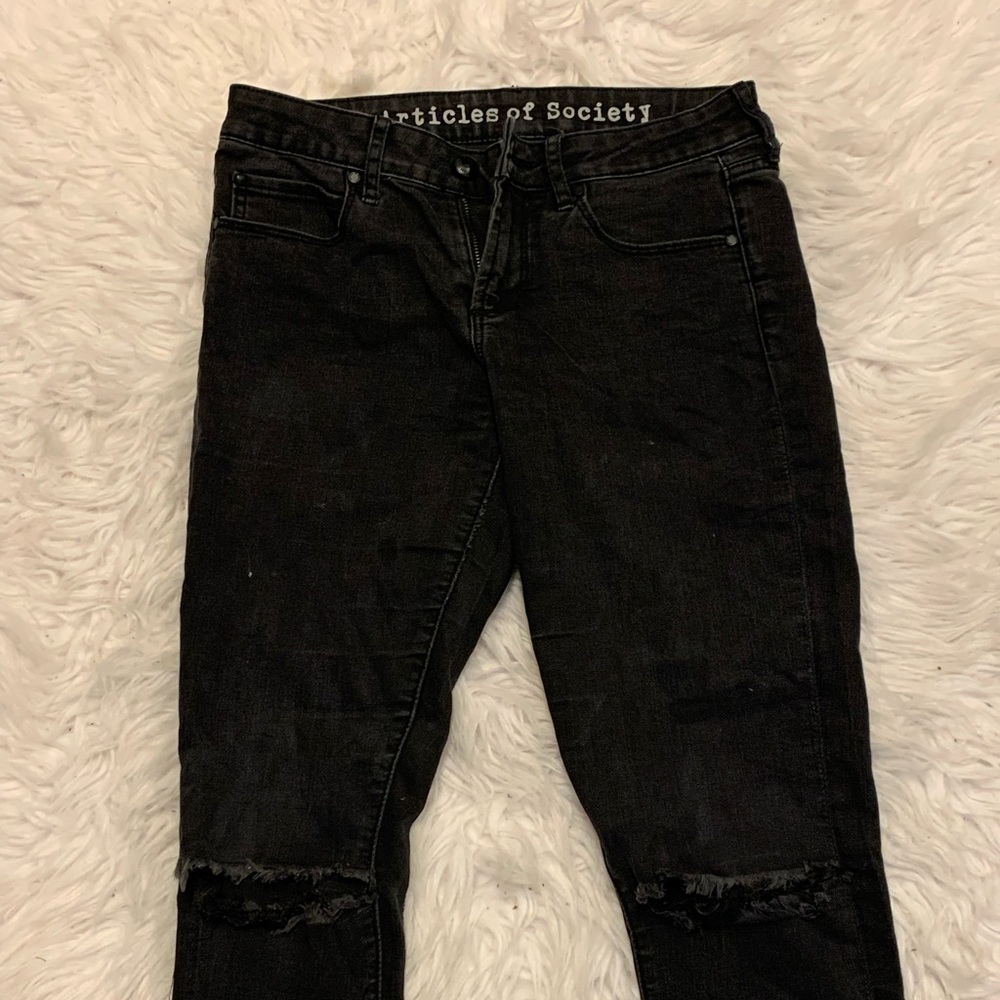 black jeans with rips on knee